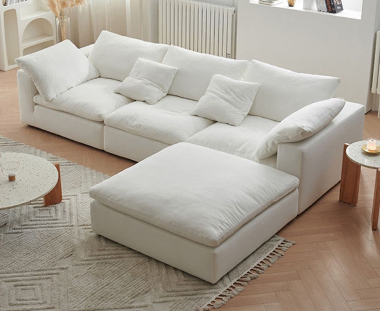 Cream four-piece sectional sofa with chaise in a bright living room