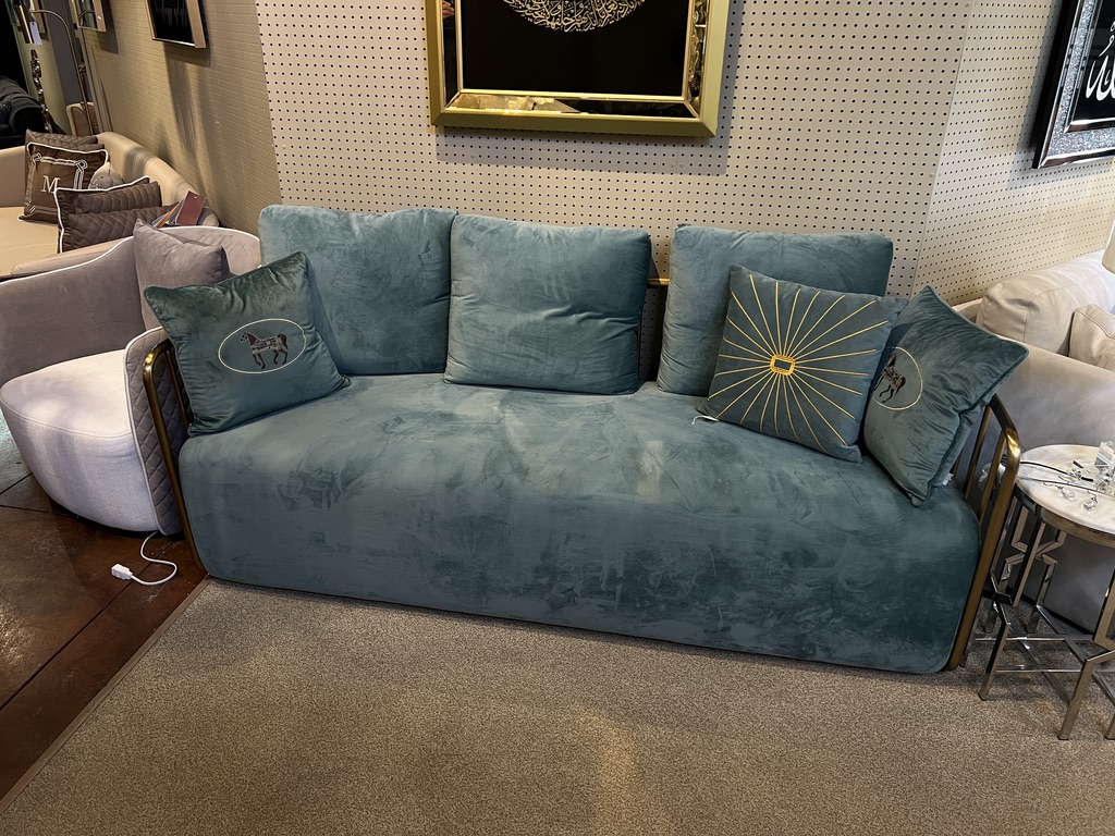 Muted Teal Sofa with Gold-Tone Rails — showroom photograph