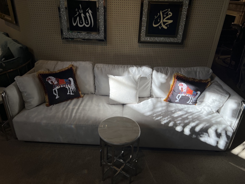 Cream Sofa with Metallic Side Rails — showroom photograph
